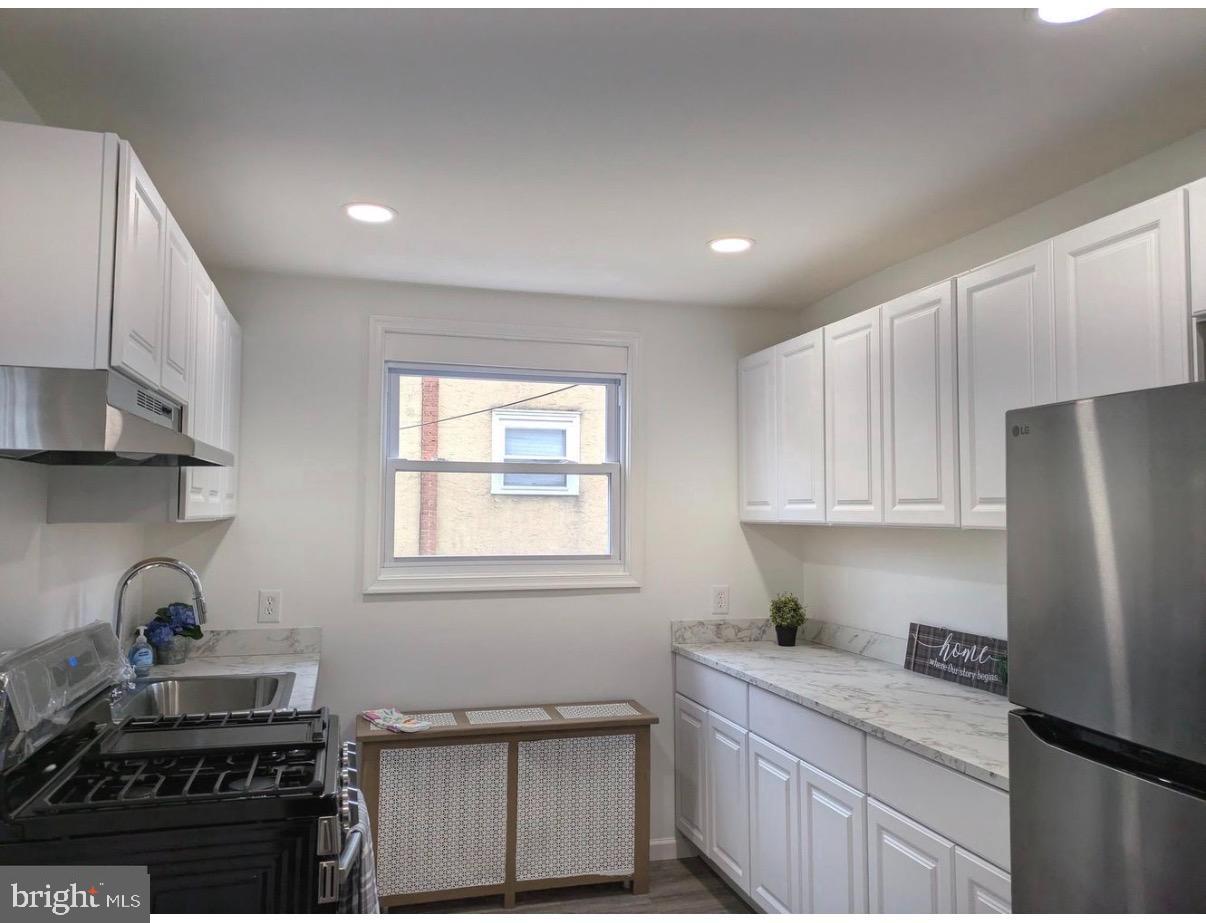 417 Copley Road Upper Darby, PA 19082 - Photo 3 of 14 a kitchen with stainless steel appliances granite countertop a stove a sink and a refrigerator