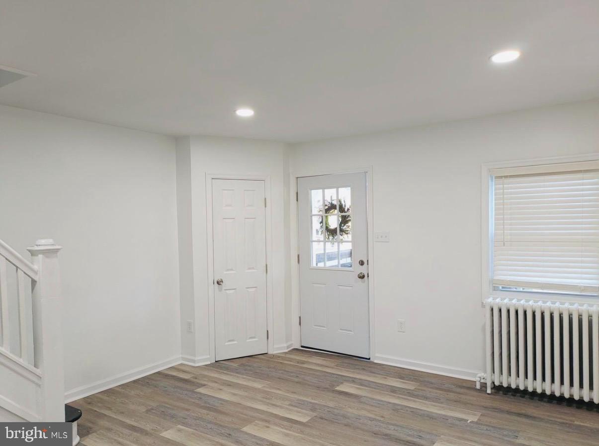 417 Copley Road Upper Darby, PA 19082 - Photo 4 of 14 an empty room with wooden floor and windows