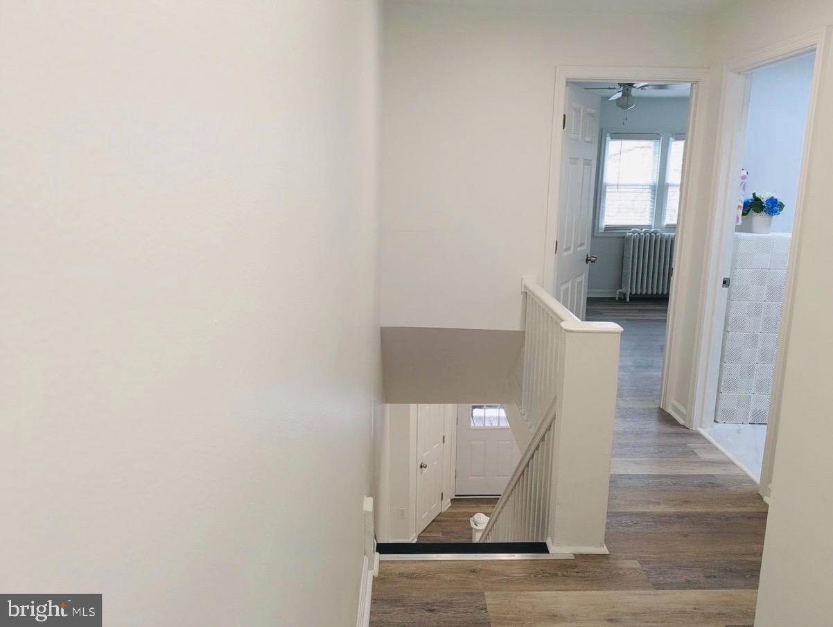 417 Copley Road Upper Darby, PA 19082 - Photo 8 of 14 a view of a hallway with wooden floor and staircase