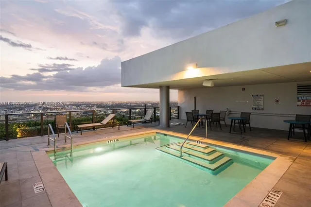 a view of a swimming pool with a bench and a couch