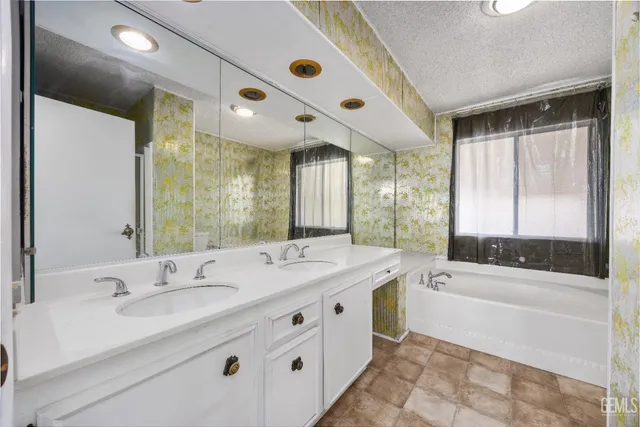 a bath tub sitting in a bathroom next to a window