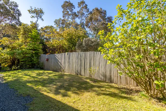 a view of swimming pool with wooden fence