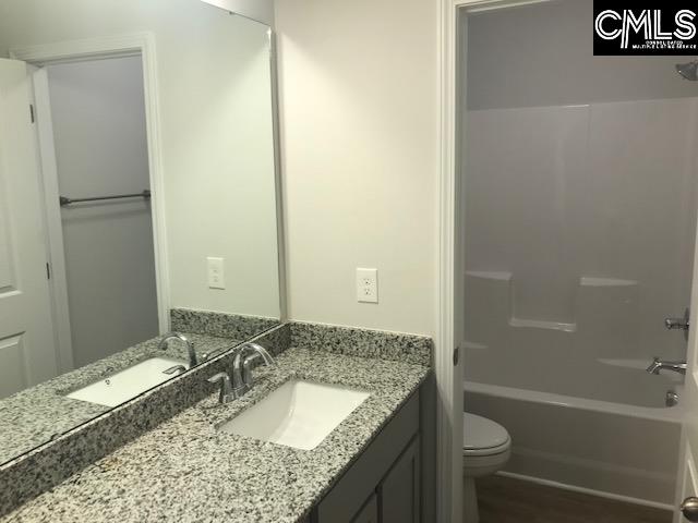 1069 Acacia Lane Columbia, SC 29229 - Photo 10 of 11 a bathroom with a granite countertop sink and a mirror