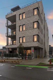 a view of a brick building next to a road