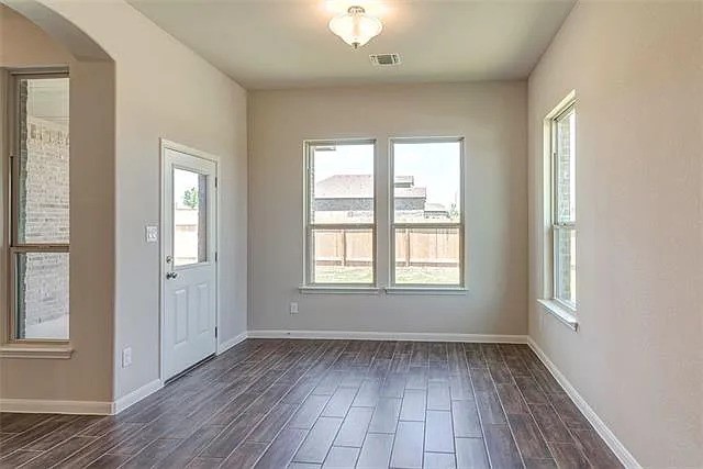 20008 Navarre Terrace Pflugerville, TX 78660 - Photo 5 of 18 an empty room with wooden floor and windows