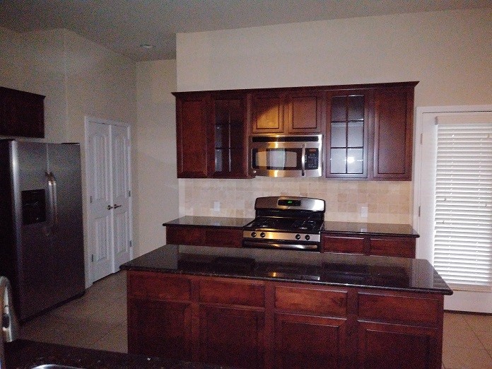 348 Stone View Trail Austin, TX 78737 - Photo 9 of 26 Gas stove, microwave, and stainless refrigerator make cooking easy