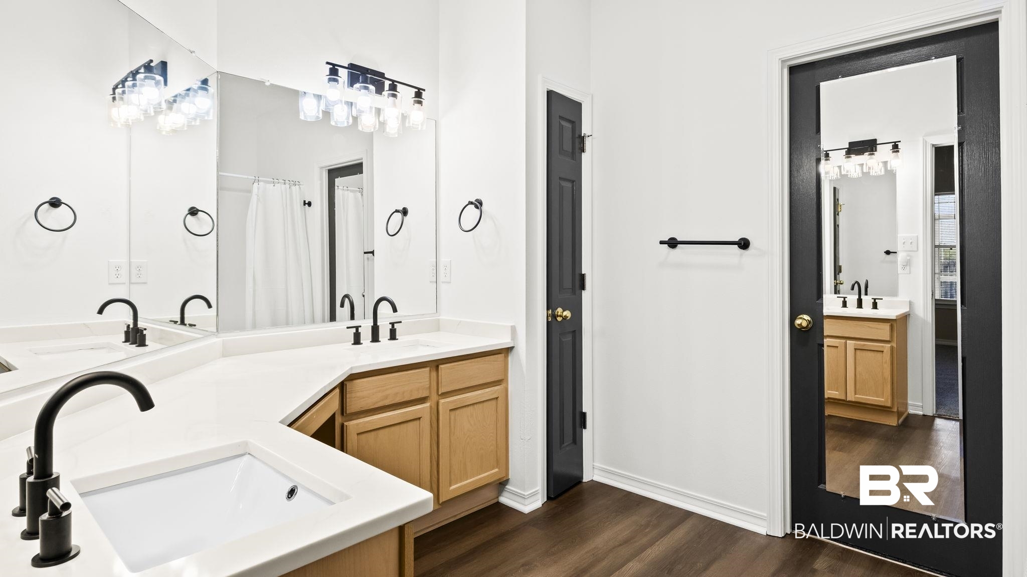 2651 South Juniper Street, Unit 705 Foley, AL 36535 - Photo 15 of 37 Bathroom featuring a dual vanity with white countertops, undermount sinks, and matte black fixtures