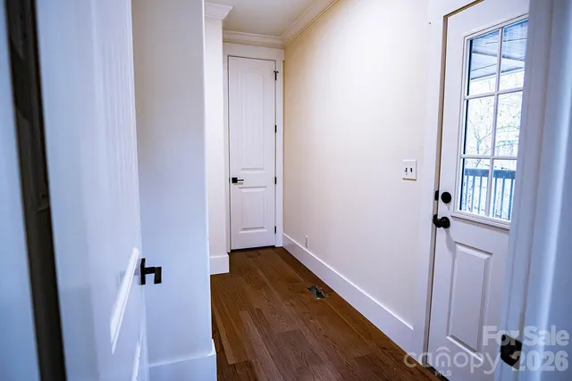 a view of a hallway with wooden floor