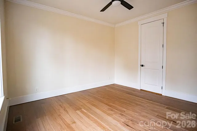 a bathroom with a granite countertop sink a toilet a mirror and shower