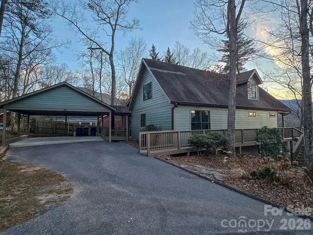 a view of a house with porch and chairs