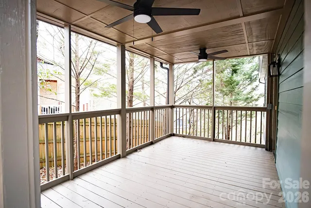 a balcony with wooden floor and outdoor seating