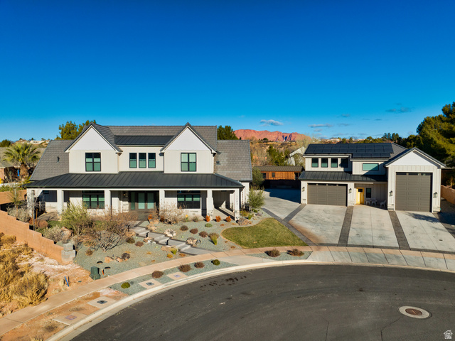 1283 North Gallen Road Santa Clara, UT 84765 - Photo 9 of 103 Modern inspired farmhouse featuring a standing seam roof, covered porch, roof mounted solar panels, driveway, and board and batten siding