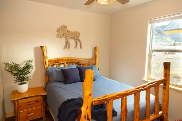 a bedroom with a bed and window