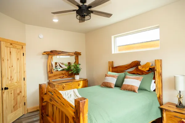 a bedroom with a bed and wooden floor