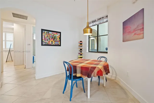 a dining room with furniture and window