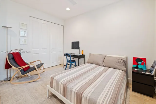 a bedroom with a bed and a chair