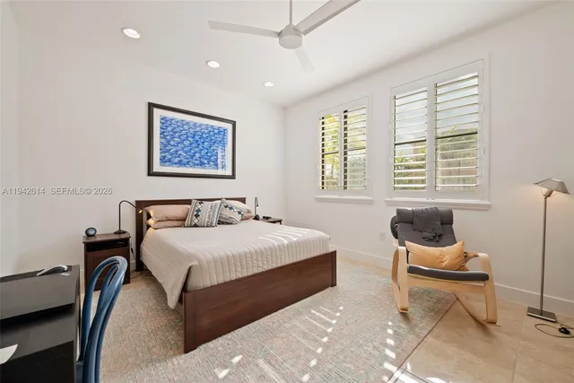 a bedroom with a bed and glass window