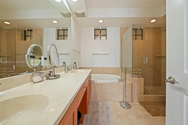 a bathroom with a tub sink and mirror