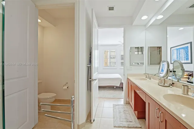 a spacious bathroom with a granite countertop sink a toilet and a bathtub
