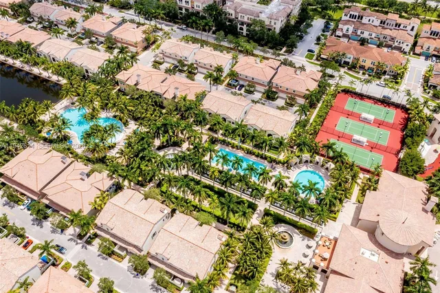 an aerial view of residential house with outdoor space and trees all around