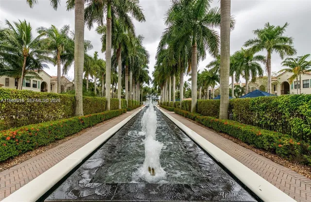a view of a swimming pool with sitting area and furniture