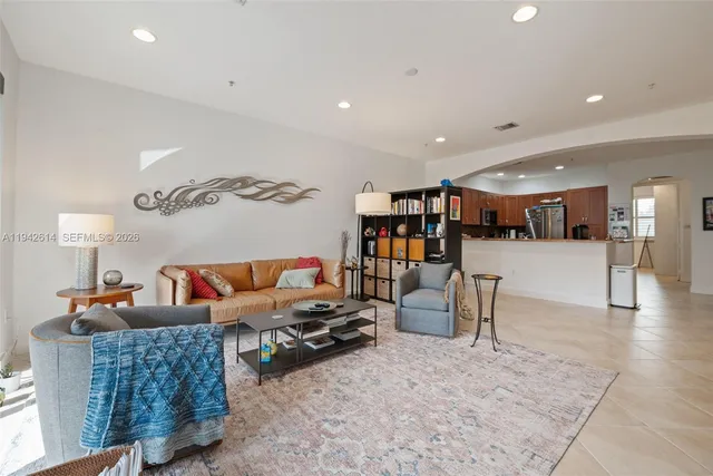 a living room with furniture and a book shelf