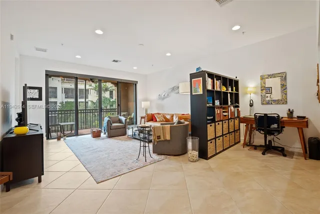 a living room with furniture and large windows