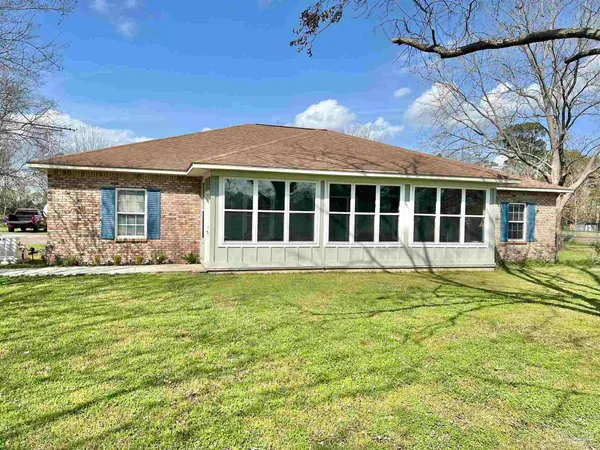a view of a house with a backyard