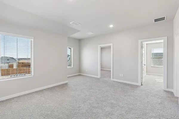 an empty room with a empty space and windows