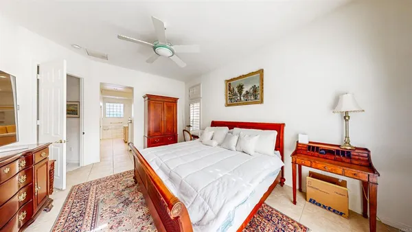 a bedroom with a bed and a book shelf
