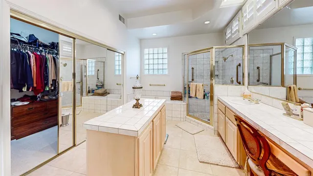 a large bathroom with a double vanity sink a large mirror and shower