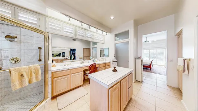 a bathroom with a sink vanity mirror and toilet