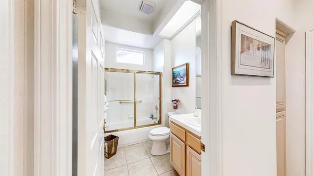 a view of a patio with table and chairs potted plants and large tree