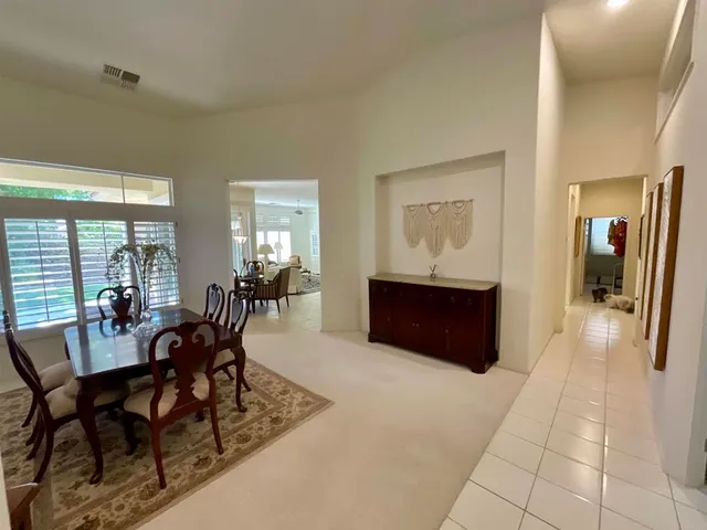 a view of a backyard with table and chairs