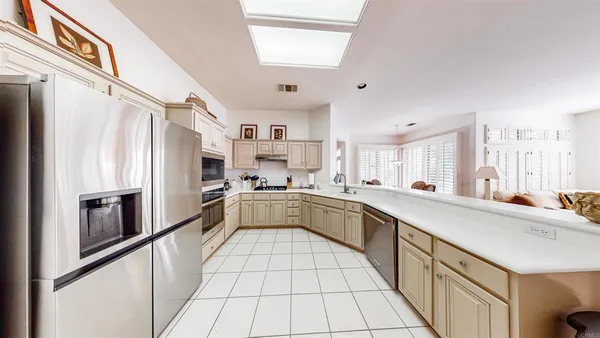 a large white kitchen with cabinets
