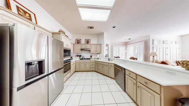 a large white kitchen with cabinets