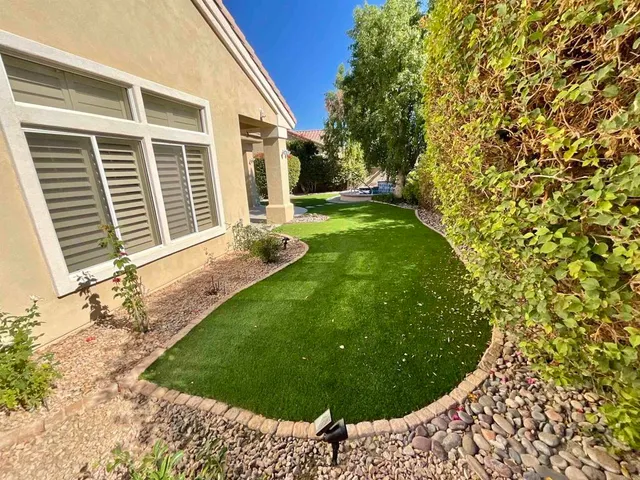a bedroom with a bed and a flat tv screen on dresser