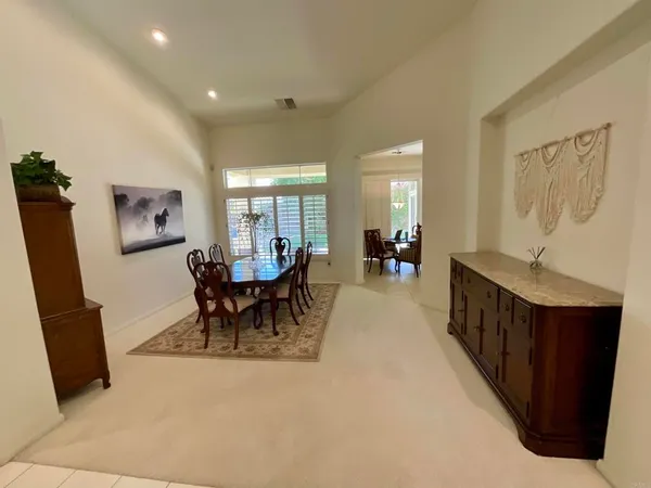 a bedroom with a bed and a flat tv screen on dresser