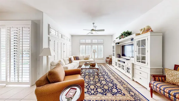 a living room with furniture fireplace and a large window