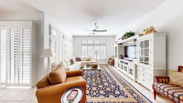 a living room with furniture fireplace and a large window