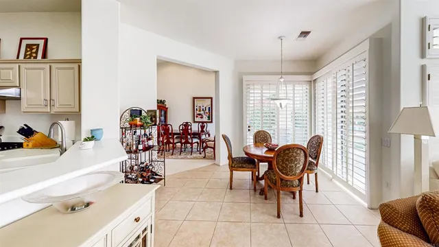 a view of a dining room with furniture and chandelier