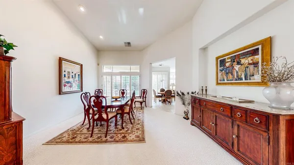 a view of a dining room and hall with furniture