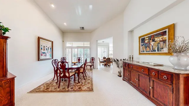 a view of a dining room and hall with furniture