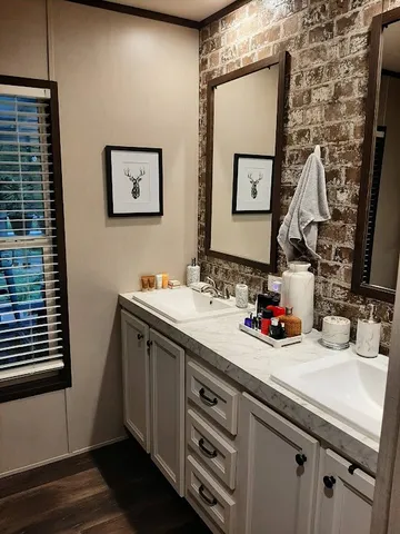a bathroom with a double vanity sink and a mirror