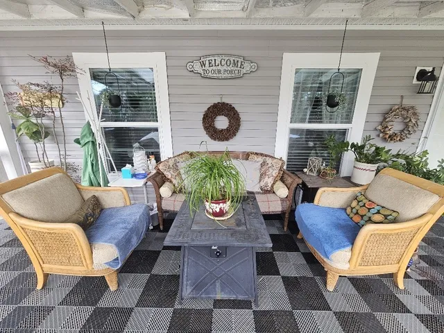 a view of a dining room with furniture and a window