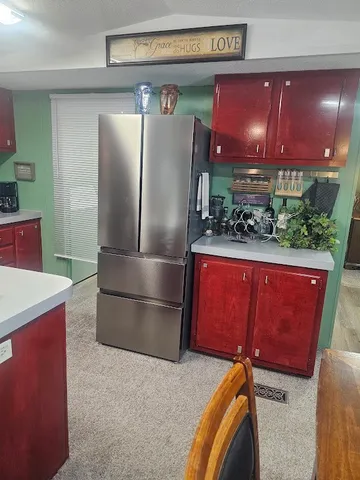 a kitchen with stainless steel appliances kitchen island granite countertop a sink a stove and a microwave