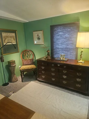 a bedroom with a bed and a night stand