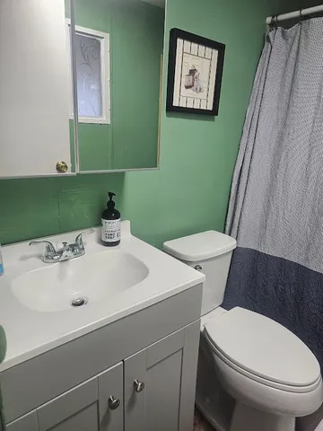 a bedroom with a bed and a lamp