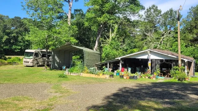 a backyard of a house with barbeque oven table and chairs