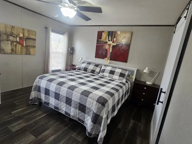 a bedroom with a bed and dresser with mirror